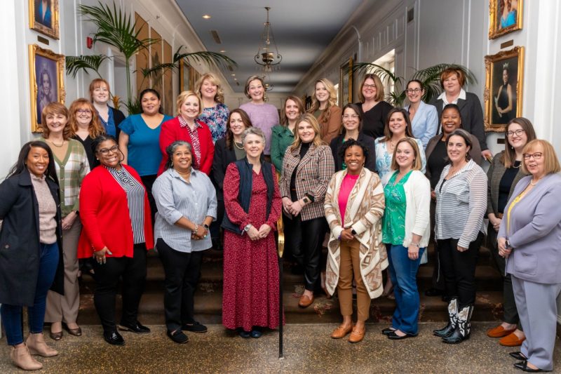 A group photo of about 25 women.