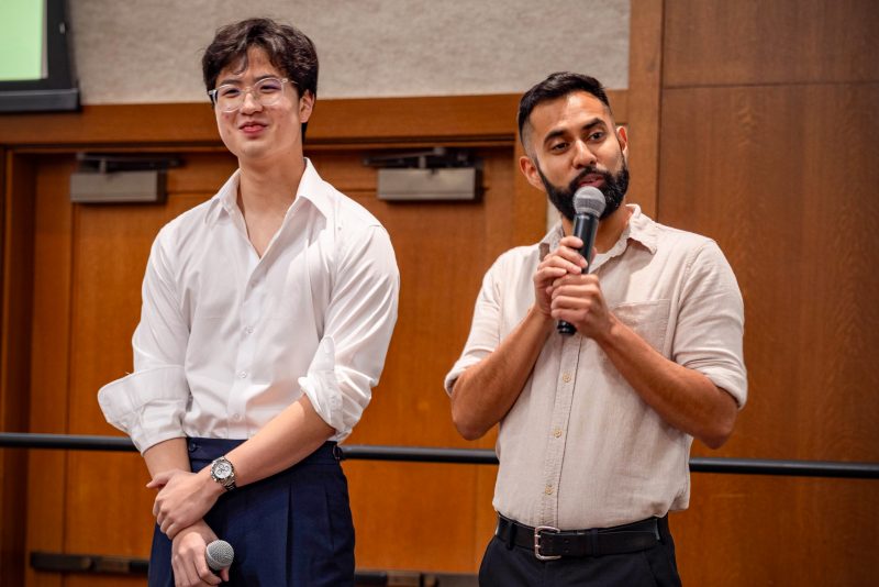 Two students on stage with microphones